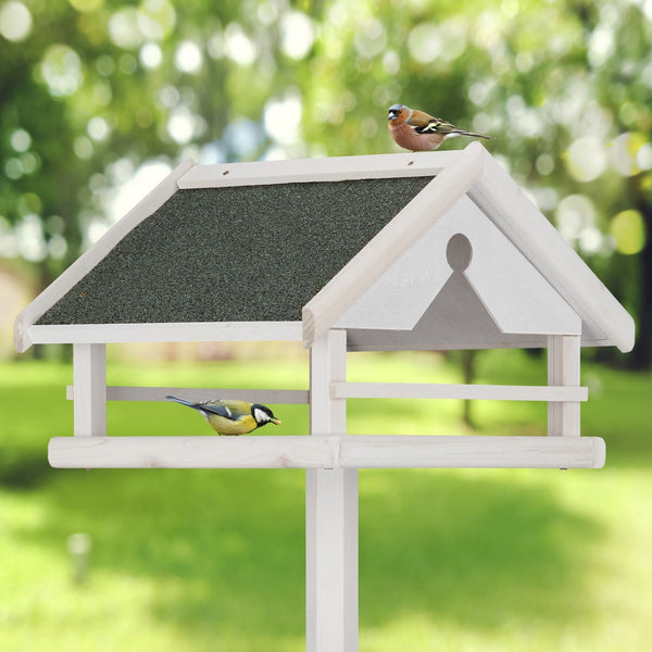 Wit vogelvoederhuisje op standaard