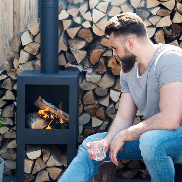 Terrace heater with wood storage