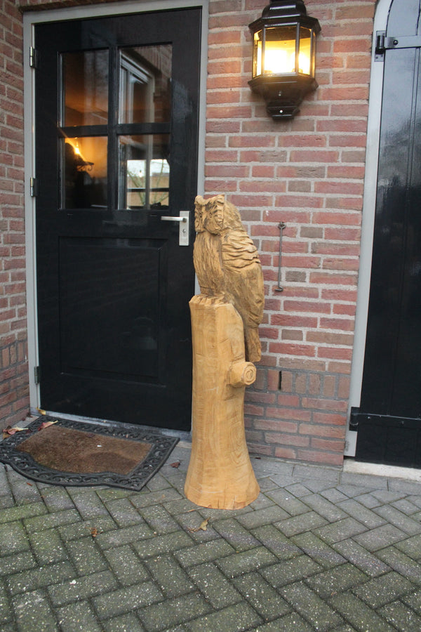 Wooden sculpture owl on trunk