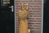 Wooden sculpture owl on trunk