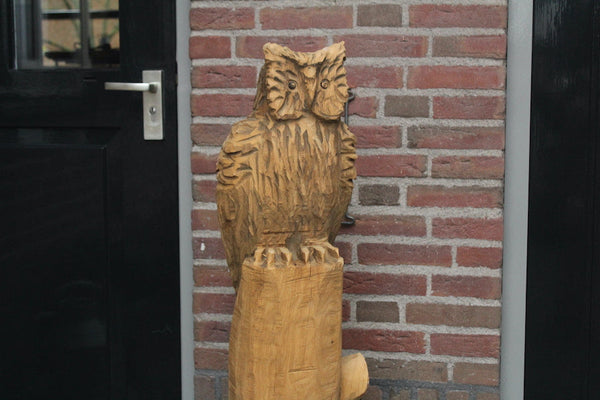 Wooden sculpture owl on trunk