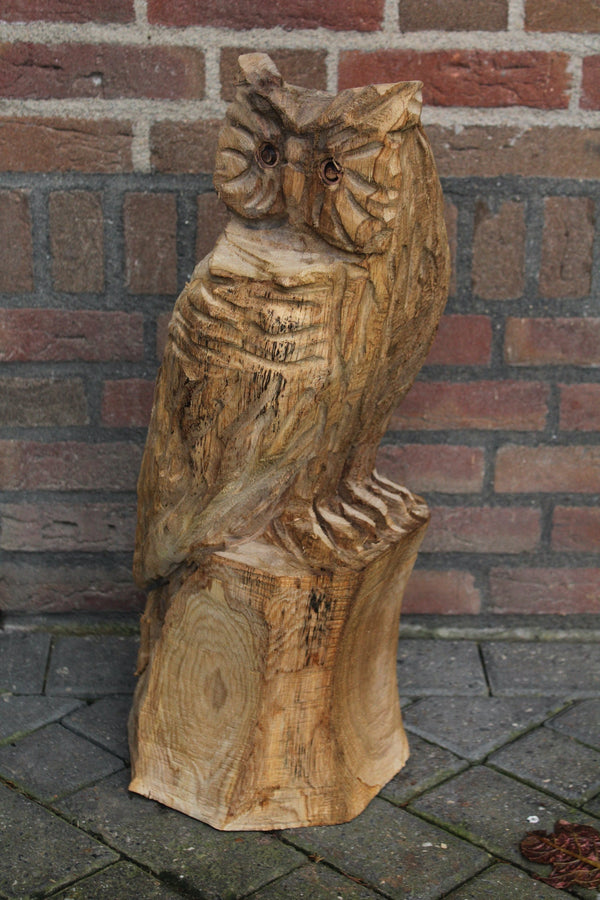Wooden sculpture owl on trunk