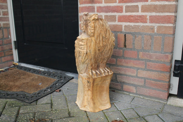 Wooden sculpture owl on trunk