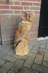 Wooden sculpture owl on trunk