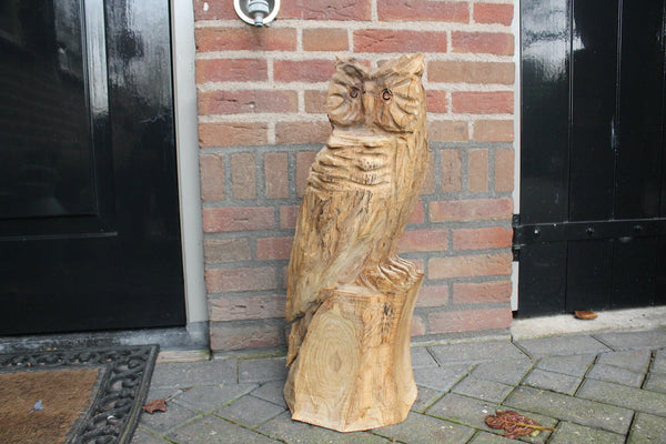 Wooden sculpture owl on trunk